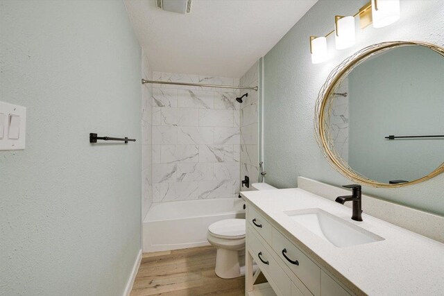 7906 Swindon Ln, Austin, TX 78745 - full bathroom with vanity, wood finished floors,  shower combination, and a textured wall