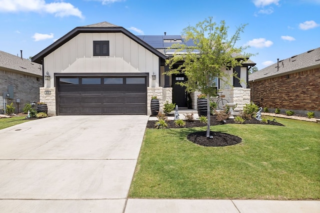 614 W Martingale St W, Georgetown, TX 78633 - view of front of property with board and batten siding, a front lawn, roof mounted solar panels, concrete driveway, and stone siding