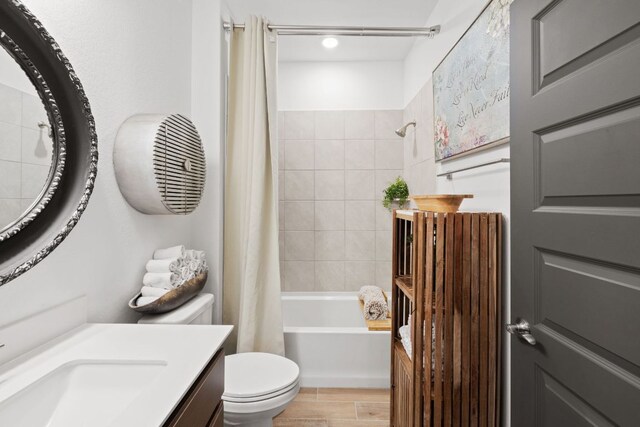 614 W Martingale St W, Georgetown, TX 78633 - bathroom with vanity, radiator heating unit, shower / tub combo, and wood finished floors