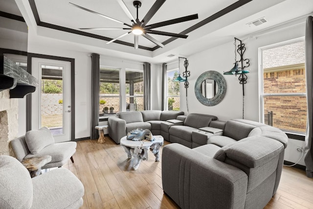 614 W Martingale St W, Georgetown, TX 78633 - living area with a raised ceiling, light wood-type flooring, a ceiling fan, and ornamental molding