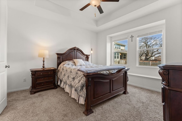 2004 Long Shadow Ln, Georgetown, TX 78628 - bedroom with light colored carpet, a tray ceiling, and ceiling fan