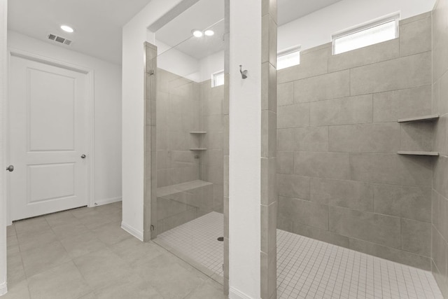 2004 Long Shadow Ln, Georgetown, TX 78628 - bathroom with a tile shower, tile patterned floors, and recessed lighting