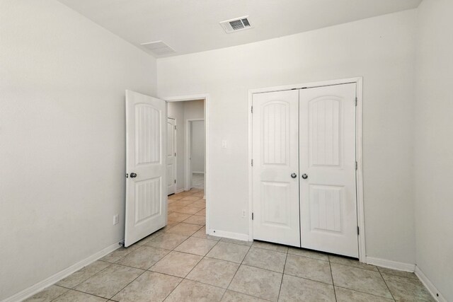 2516 Silver Fern Ln, Pflugerville, TX 78660 - unfurnished bedroom with light tile patterned flooring and a closet