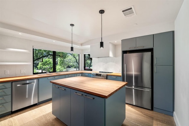 419 Brady Ln, Austin, TX 78746 - kitchen featuring wooden counters, stainless steel appliances, light wood-style flooring, backsplash, and recessed lighting