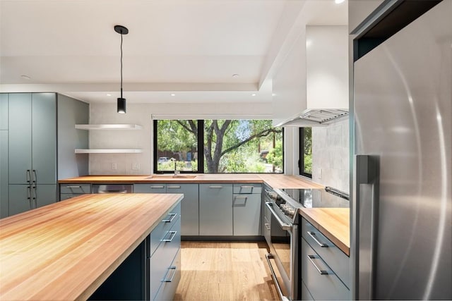 419 Brady Ln, Austin, TX 78746 - kitchen featuring wooden counters, stainless steel appliances, custom exhaust hood, gray cabinetry, and recessed lighting