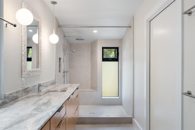 419 Brady Ln, Austin, TX 78746 - bathroom with a tile shower, vanity, tile patterned floors, and recessed lighting