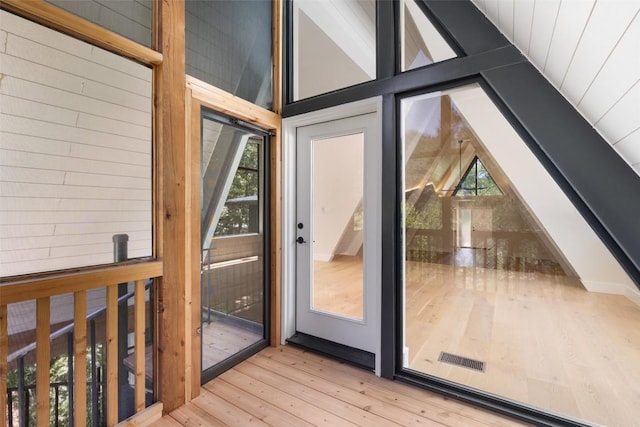 419 Brady Ln, Austin, TX 78746 - doorway with vaulted ceiling, hardwood / wood-style floors, and healthy amount of natural light