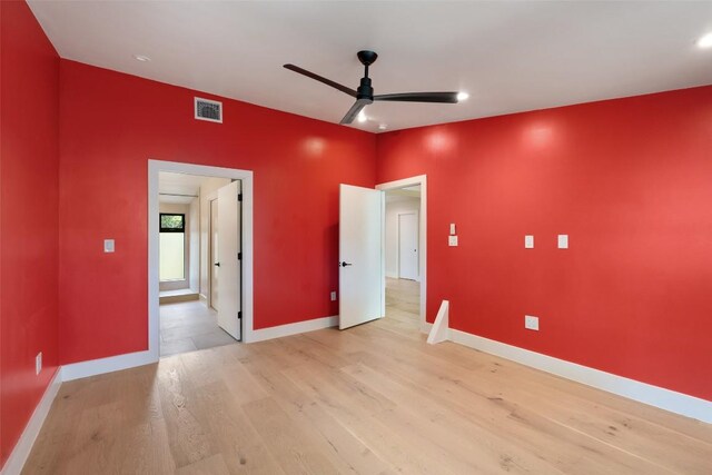 419 Brady Ln, Austin, TX 78746 - unfurnished bedroom featuring light wood finished floors, recessed lighting, connected bathroom, and a ceiling fan