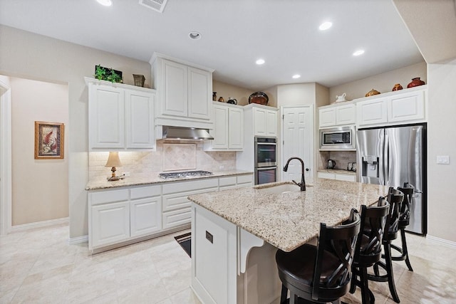 128 Lady Bird Ln, Georgetown, TX 78628 - kitchen featuring appliances with stainless steel finishes, under cabinet range hood, recessed lighting, backsplash, and white cabinets