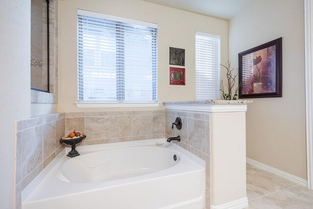 128 Lady Bird Ln, Georgetown, TX 78628 - full bathroom with a garden tub, healthy amount of natural light, and tile patterned flooring