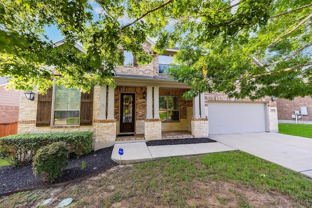 128 Lady Bird Ln, Georgetown, TX 78628 - view of front of house with covered porch, driveway, a garage, stone siding, and brick siding