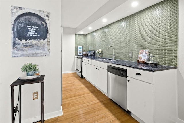 kitchen featuring stainless steel appliances, light wood-type flooring, white cabinets, recessed lighting, and tasteful backsplash