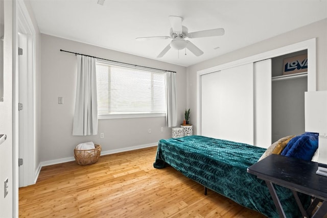 bedroom with wood finished floors, a closet, and ceiling fan