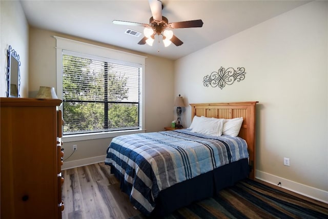 17800 Edgewood Way Unit 203, Jonestown, TX 78645 - bedroom with multiple windows, wood finished floors, and a ceiling fan
