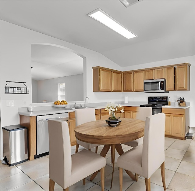 12701 Paloma Blanca Way, Del Valle, TX 78617 - kitchen featuring dishwasher, black / electric stove, stainless steel microwave, vaulted ceiling, and light countertops