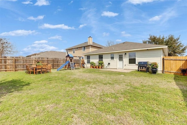 12701 Paloma Blanca Way, Del Valle, TX 78617 - rear view of property featuring a playground, a fenced backyard, and a patio
