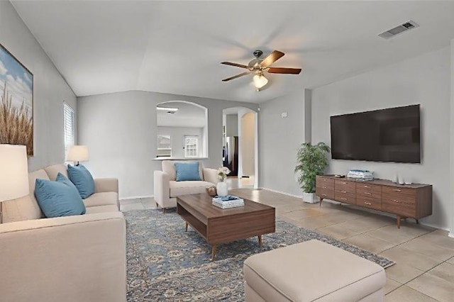 12701 Paloma Blanca Way, Del Valle, TX 78617 - living area with arched walkways, a ceiling fan, light tile patterned flooring, and vaulted ceiling