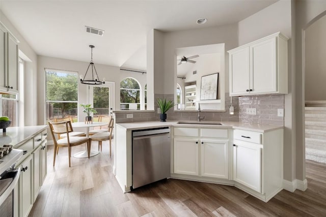 4604 Hibiscus Valley Dr, Austin, TX 78739 - kitchen with appliances with stainless steel finishes, a ceiling fan, tasteful backsplash, light countertops, and vaulted ceiling