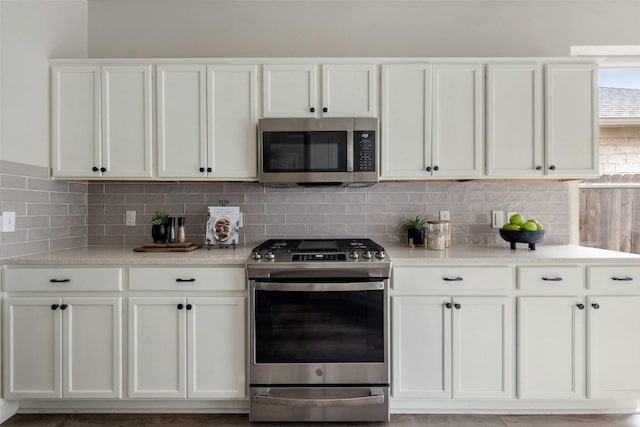 4604 Hibiscus Valley Dr, Austin, TX 78739 - kitchen with appliances with stainless steel finishes, white cabinetry, and backsplash