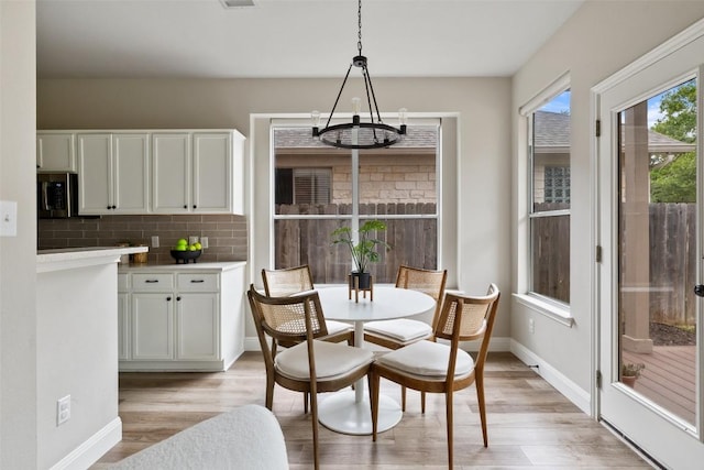 4604 Hibiscus Valley Dr, Austin, TX 78739 - dining space featuring a chandelier and light wood finished floors