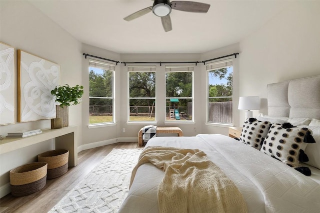 4604 Hibiscus Valley Dr, Austin, TX 78739 - bedroom featuring wood finished floors, multiple windows, and a ceiling fan