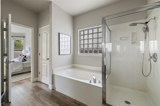 4604 Hibiscus Valley Dr, Austin, TX 78739 - ensuite bathroom with a shower stall, a garden tub, and wood finished floors