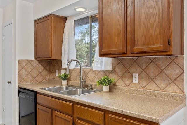9400 Canus Dr, Austin, TX 78748 - kitchen featuring black dishwasher, light countertops, decorative backsplash, and brown cabinets