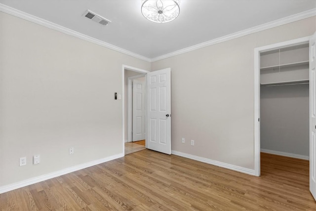 9400 Canus Dr, Austin, TX 78748 - unfurnished bedroom featuring a spacious closet, wood finished floors, ornamental molding, and a closet