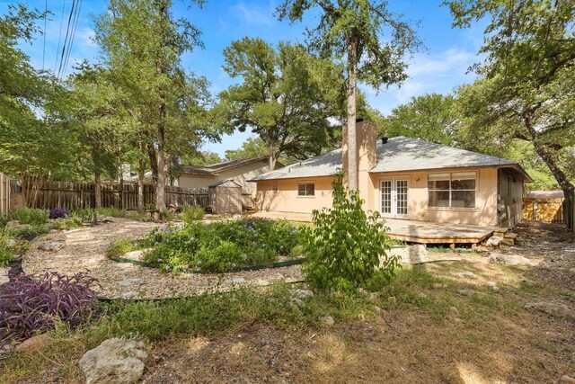 9400 Canus Dr, Austin, TX 78748 - back of house with a fenced backyard, a chimney, and a deck