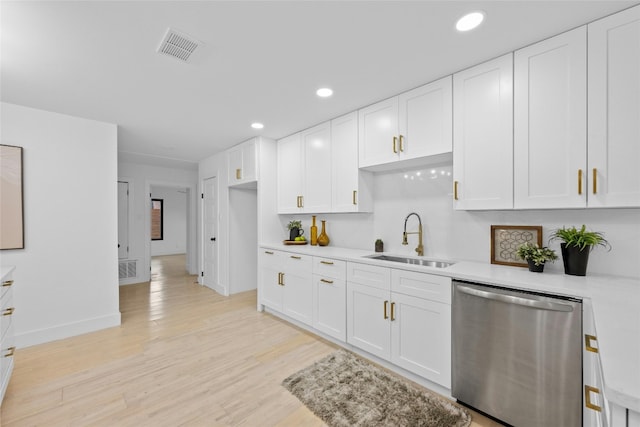 1305 Ridgehaven Dr, Austin, TX 78723 - kitchen featuring dishwasher, light countertops, white cabinets, light wood-style flooring, and recessed lighting