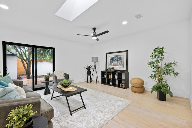 1305 Ridgehaven Dr, Austin, TX 78723 - living area featuring wood finished floors, a skylight, recessed lighting, and a ceiling fan