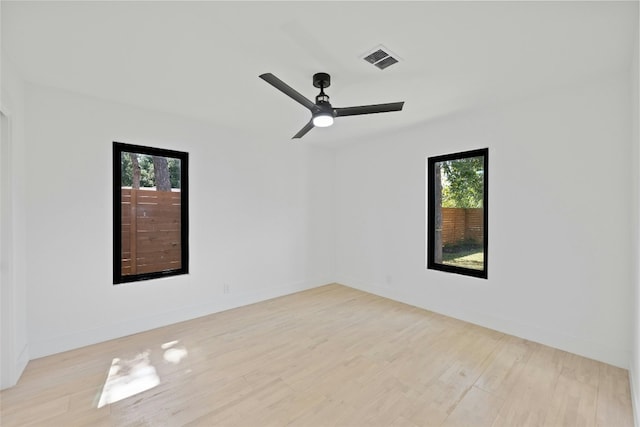 1305 Ridgehaven Dr, Austin, TX 78723 - spare room with healthy amount of natural light, wood finished floors, and ceiling fan