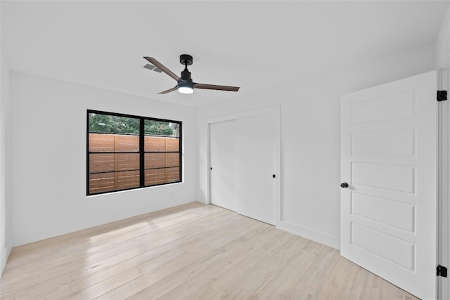 1305 Ridgehaven Dr, Austin, TX 78723 - unfurnished bedroom with a closet, light wood-style floors, and a ceiling fan
