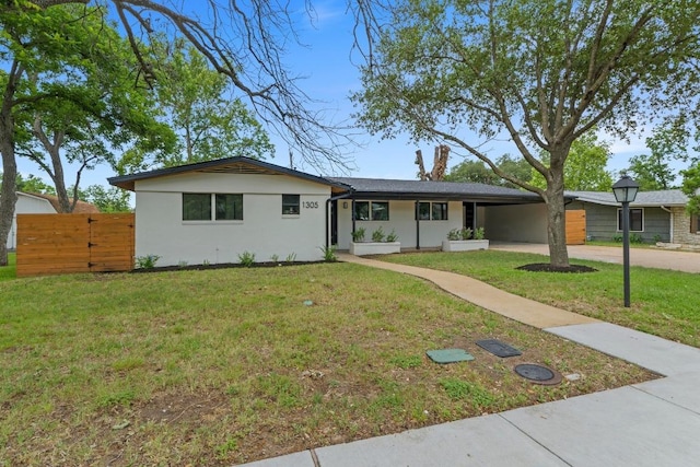 1305 Ridgehaven Dr, Austin, TX 78723 - ranch-style house with concrete driveway, stucco siding, a front lawn, a carport, and a gate
