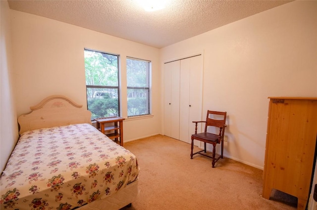 205 Mesa Verde St, Cedar Park, TX 78613 - bedroom featuring light colored carpet, a closet, and a textured ceiling