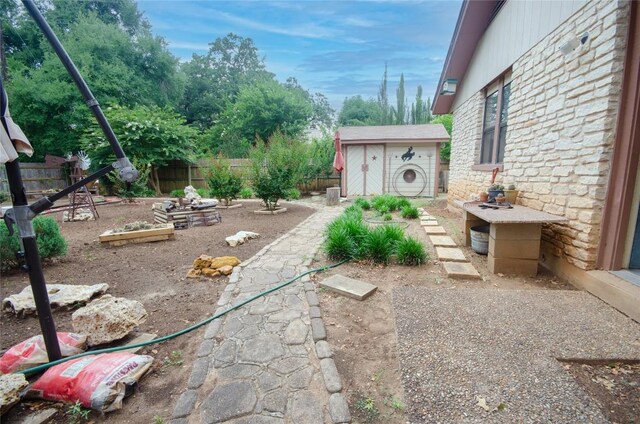 205 Mesa Verde St, Cedar Park, TX 78613 - fenced backyard featuring a garden and a shed