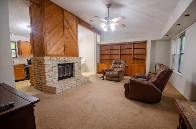 205 Mesa Verde St, Cedar Park, TX 78613 - living area with lofted ceiling, light colored carpet, a fireplace, ceiling fan, and a textured ceiling