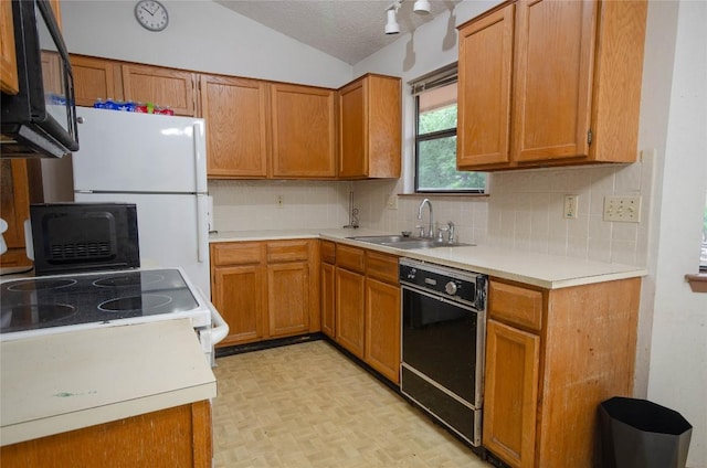 205 Mesa Verde St, Cedar Park, TX 78613 - kitchen featuring black appliances, decorative backsplash, light countertops, lofted ceiling, and brown cabinetry