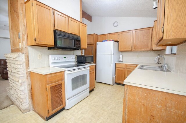 205 Mesa Verde St, Cedar Park, TX 78613 - kitchen featuring white appliances, vaulted ceiling, light countertops, decorative backsplash, and light floors
