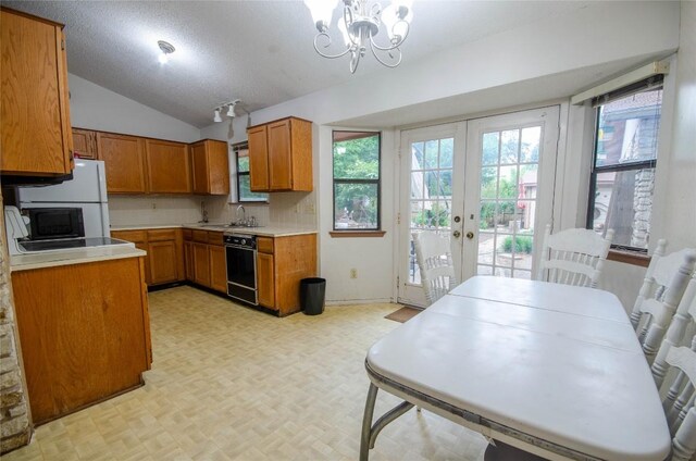 205 Mesa Verde St, Cedar Park, TX 78613 - kitchen with brown cabinetry, lofted ceiling, light countertops, and healthy amount of natural light