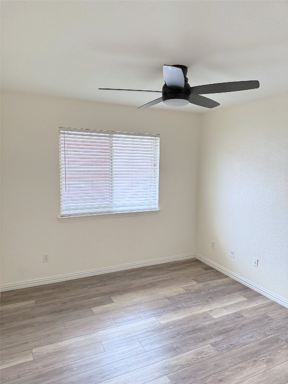 1522 Tamar Ln, Austin, TX 78727 - empty room with plenty of natural light, ceiling fan, and wood finished floors