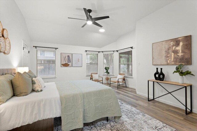 1522 Tamar Ln, Austin, TX 78727 - bedroom with lofted ceiling, multiple windows, wood finished floors, and a ceiling fan