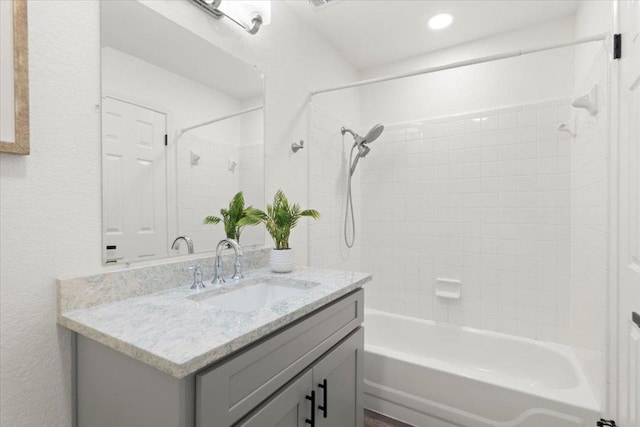 1522 Tamar Ln, Austin, TX 78727 - full bathroom with vanity, tub / shower combination, a textured wall, and recessed lighting
