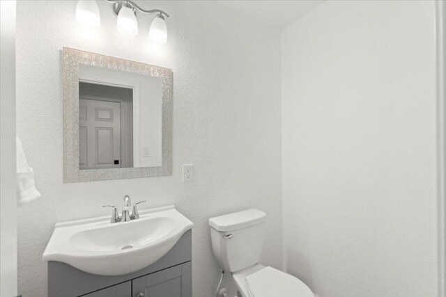 1522 Tamar Ln, Austin, TX 78727 - half bathroom featuring vanity and toilet