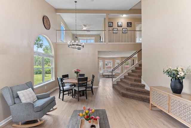 1401 Jackie Robinson Pl, Round Rock, TX 78665 - dining room featuring a chandelier, healthy amount of natural light, stairway, and a towering ceiling