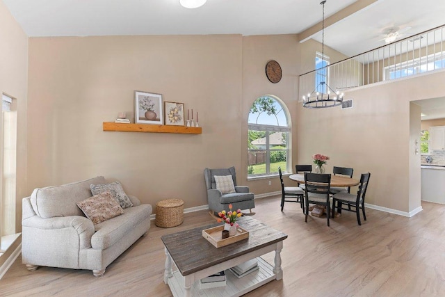 1401 Jackie Robinson Pl, Round Rock, TX 78665 - living area with wood finished floors, beam ceiling, a chandelier, and high vaulted ceiling