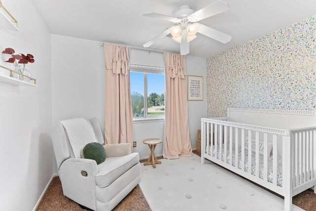 1401 Jackie Robinson Pl, Round Rock, TX 78665 - bedroom featuring wallpapered walls, a crib, a ceiling fan, and carpet