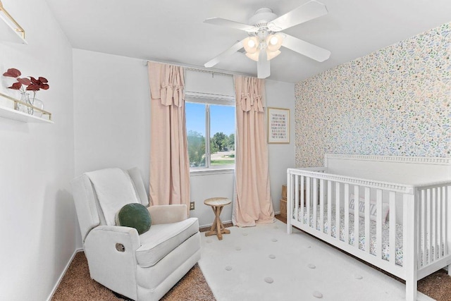 1401 Jackie Robinson Pl, Round Rock, TX 78665 - bedroom featuring wallpapered walls, a crib, a ceiling fan, and carpet