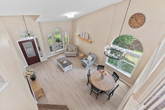 1401 Jackie Robinson Pl, Round Rock, TX 78665 - living area featuring a chandelier, wood finished floors, and a towering ceiling