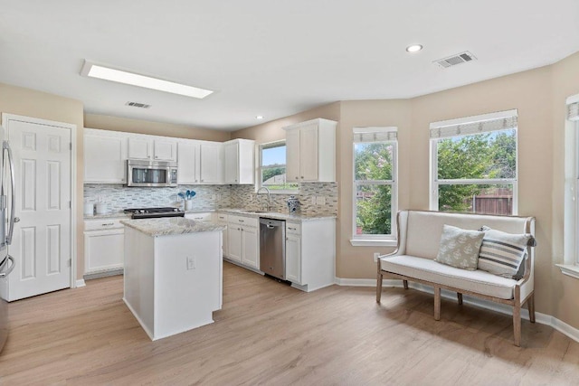 1401 Jackie Robinson Pl, Round Rock, TX 78665 - kitchen featuring appliances with stainless steel finishes, backsplash, white cabinetry, and recessed lighting